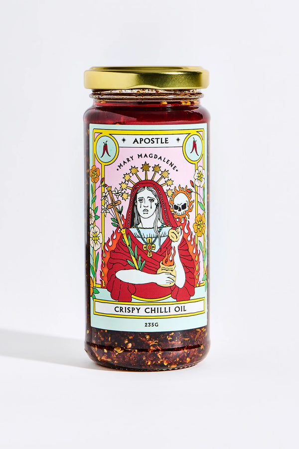 Jar of Apostle Crispy Chilli Oil, 235g, featuring a vibrant Mary Magdalene illustration on the label with a gold lid and visible chilli flakes