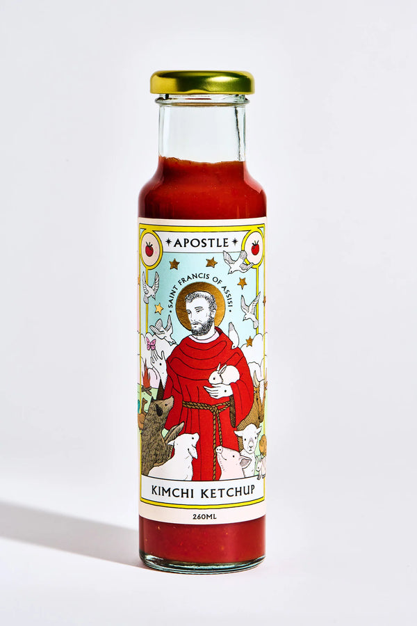 Bottle of Apostle Kimchi Ketchup, 260ml, featuring a Saint Francis of Assisi illustration on the label with animals and vibrant colours