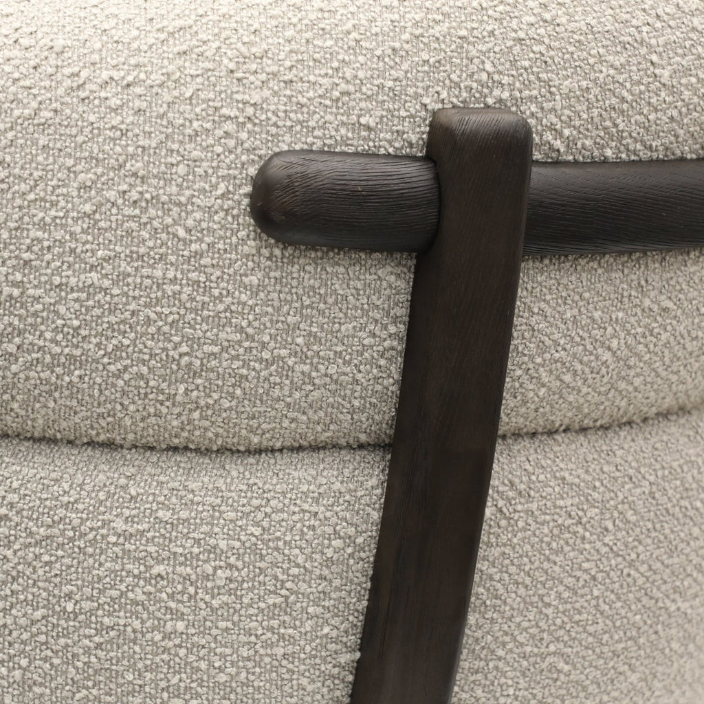 Close-up of ivory boucle fabric texture on a modern swivel chair, highlighting soft and tactile weave