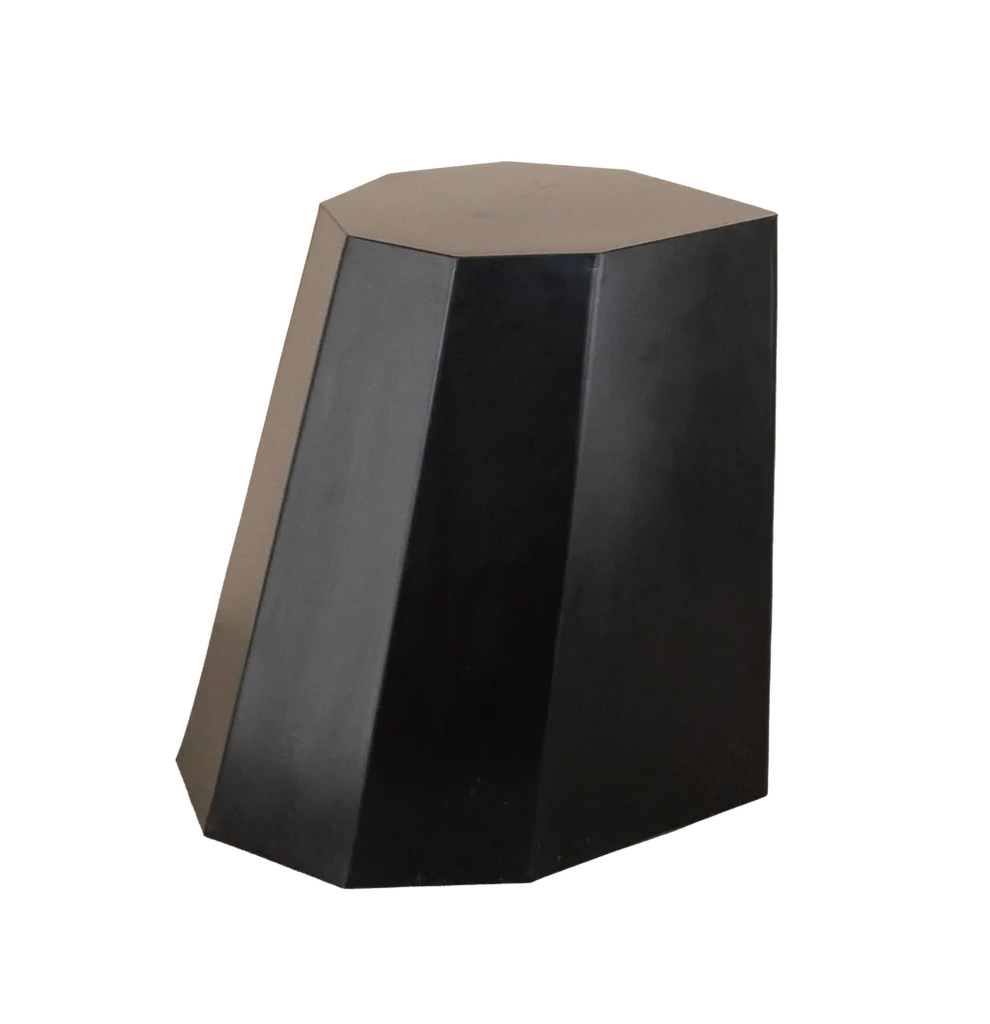 Matte black faceted stool with a sculptural silhouette, ideal as a statement seat or minimalist side table.