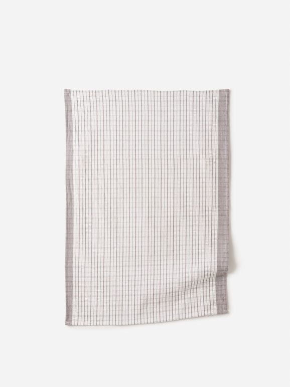 Soft grey and white check linen tea towel with muted border, laid flat against a white background.