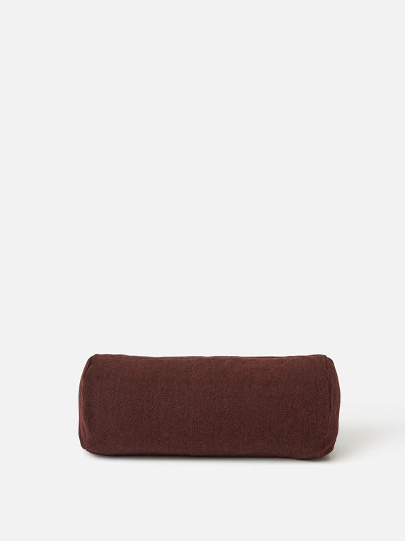 Front view of a burgundy cylindrical bolster cushion made from natural linen, shown on a clean white background.