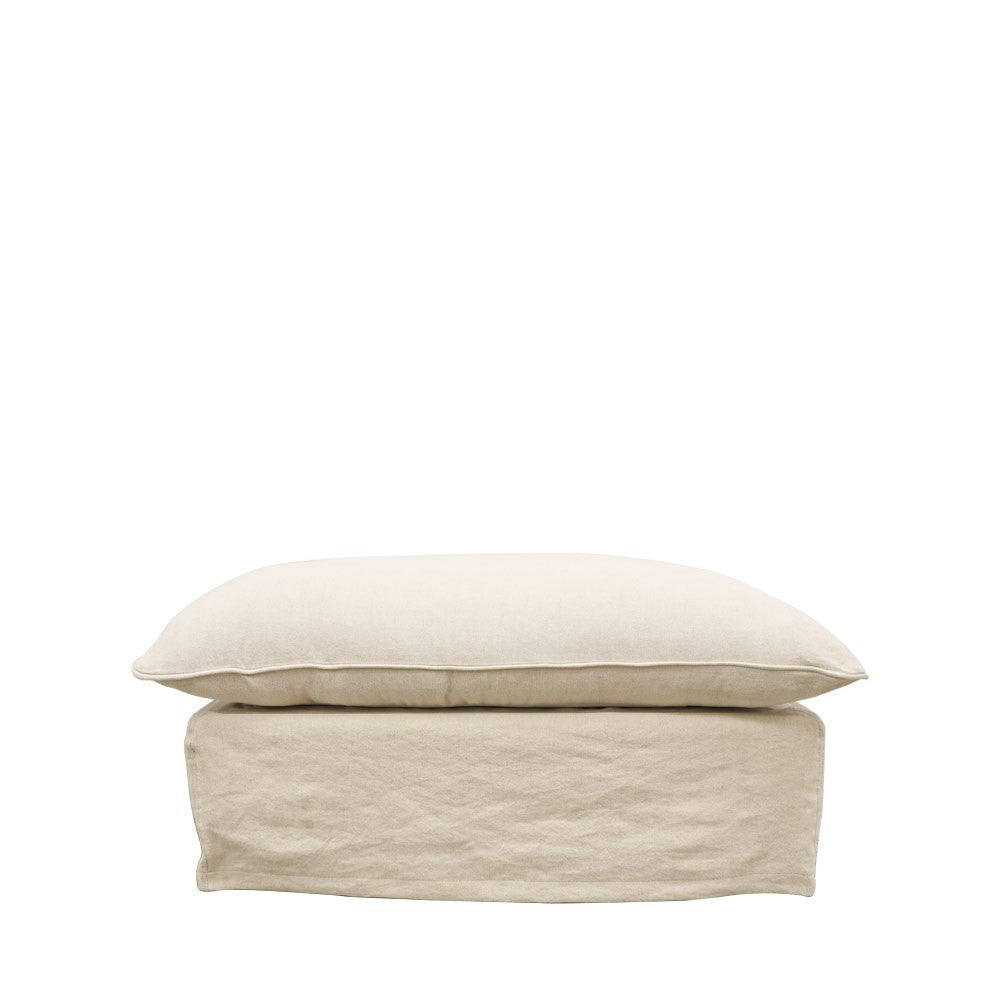 Front view of a rectangular ottoman in a soft oatmeal linen cover, with matching cushion top and tailored skirt base.