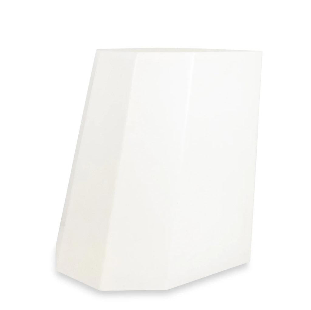 White angular stool with a geometric design and matte finish, ideal as a sculptural side table or minimalist seating option.