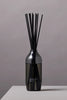 Ashley & Co black reed diffuser with sleek bottle design and minimalist branding on a neutral grey background.
