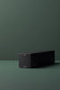 Ashley & Co diffuser box lying flat on a green surface with minimalist black packaging and subtle scent indicator dot.