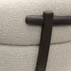 Close-up of ivory boucle fabric texture on a modern swivel chair, highlighting soft and tactile weave