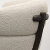 Close-up of ivory boucle fabric texture on a modern swivel chair, highlighting soft and tactile weave