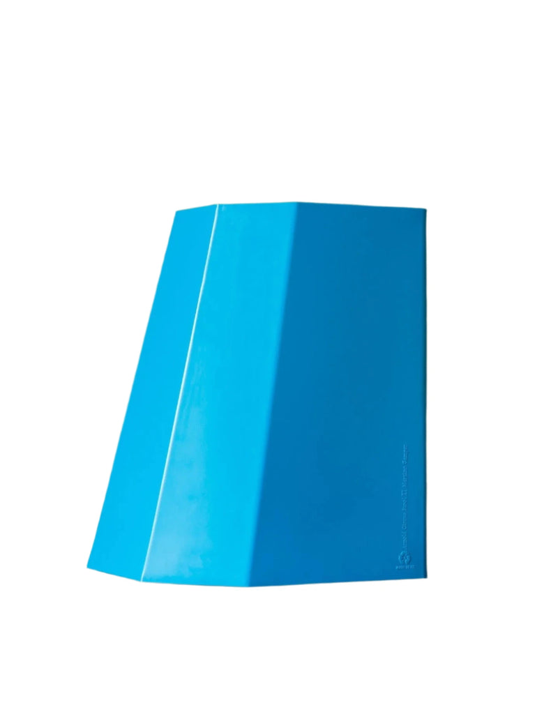 Bright blue angular stool with a modern geometric shape and glossy finish, perfect as a bold side table or casual seat.