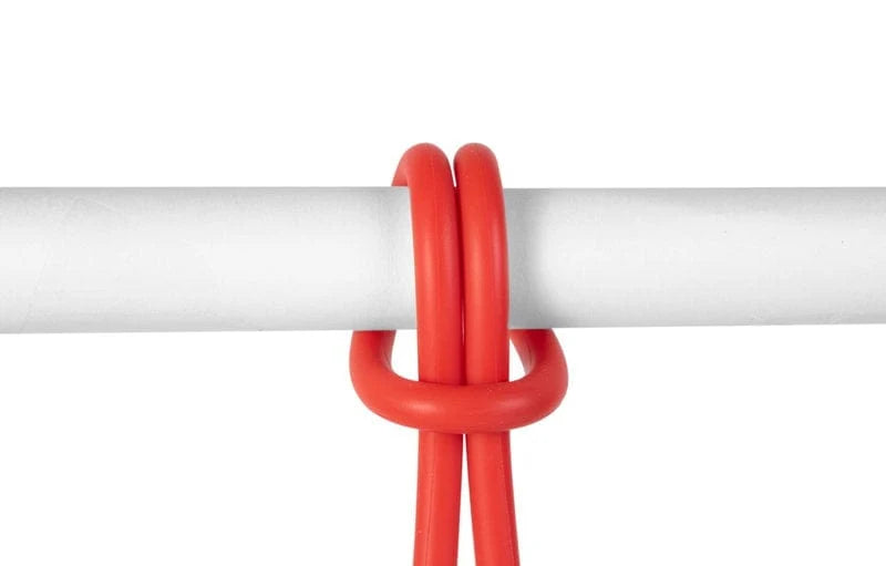 A bright red plastic hanging loop or knot accessory shown against a white background, wrapped around a white horizontal bar.
