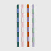 Set of four multicoloured glass straws with striped segments in pastel and jewel tones, displayed on a white background.