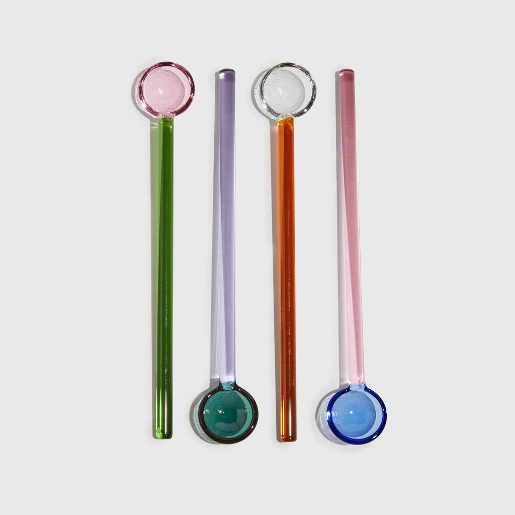 Set of four colourful glass spoons in pink, green, purple, orange and blue, perfect for serving condiments or stirring drinks.