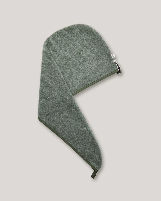 A green hair wrap with a small white brand tag on the side, shown on a solid light gray background.