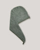 A green hair wrap with a small white brand tag on the side, shown on a solid light gray background.