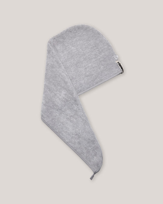 Grey head towel with a brand logo on a light gray background