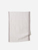 Soft grey and white check linen tea towel with muted border, laid flat against a white background.