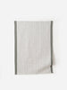 Olive green and white grid-patterned linen tea towel with dark edging, displayed flat against a white background.