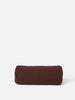 Front view of a burgundy cylindrical bolster cushion made from natural linen, shown on a clean white background.
