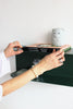 Bedside green floating shelf made in NZ out of 3mm Aluminium with small people books and a night light