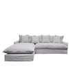 Contemporary modular sofa in soft light grey linen, styled with oversized back cushions and a relaxed tailored finish.