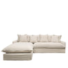 Neutral oatmeal-toned modular linen sofa with deep seating, back cushions, and a long chaise for lounging.