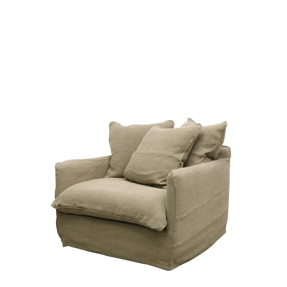 Inviting armchair in earthy olive green linen, styled with oversized cushions and a relaxed form.