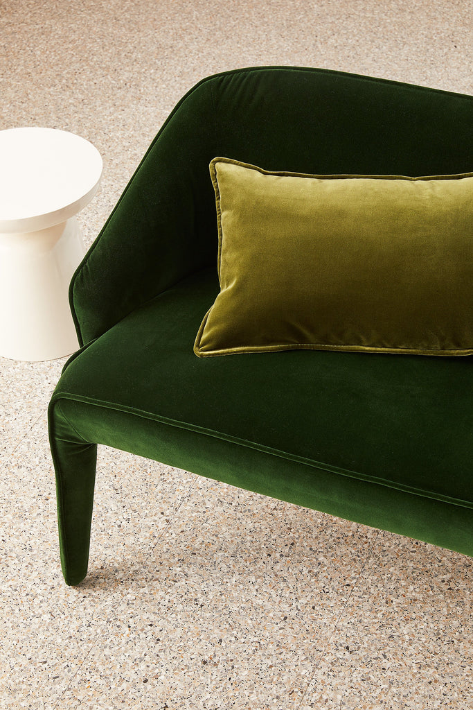 Olive green feather filled Hommey cushion on green chair 