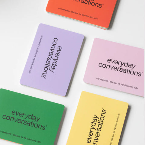 Colourful “Everyday Conversations” cards for families and kids spread out on a white surface, designed to spark engaging and meaningful discussions