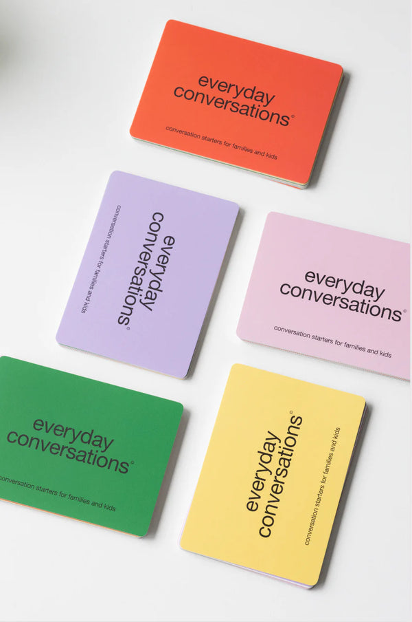Colourful “Everyday Conversations” cards for families and kids spread out on a white surface, designed to spark engaging and meaningful discussions