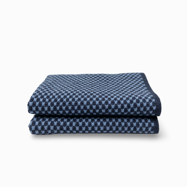 A folded navy blue cloth with a light blue geometric pattern, shown on a clean white background.