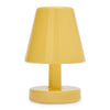 A small table lamp with a glossy mustard yellow shade, stem, and base, photographed against a plain white background.