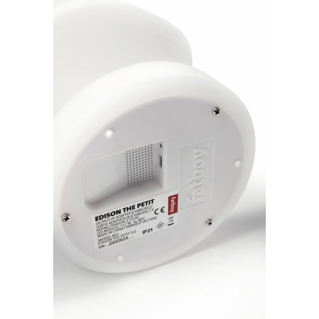 Close-up of the bottom circular base of a white Edison The Petit fatboy light fixture, showing screws, a label with specifications, and the embossed 'fatboy' logo.