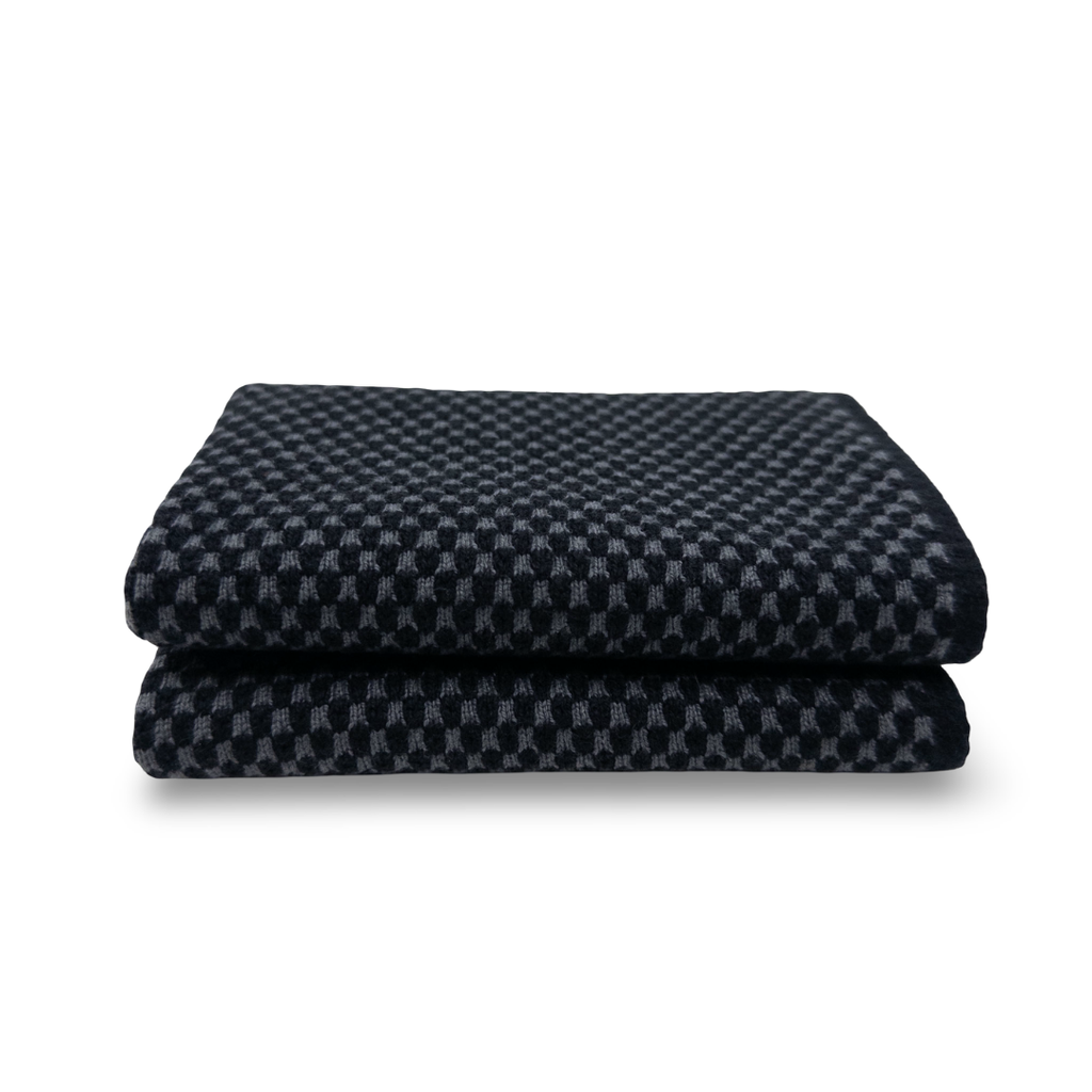 A folded dark navy blue cloth with a small-scale gray and navy checkered pattern, shown on a clean white background.