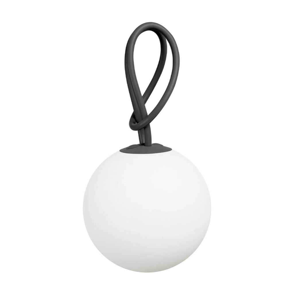 White spherical lamp with a brown handle on a white background