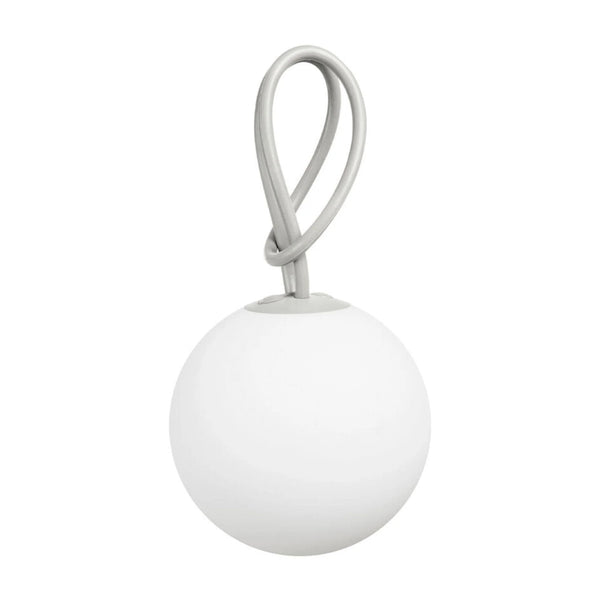A minimalist modern pendant light featuring a matte white spherical shade and a light gray braided loop handle, shown against a solid white background.