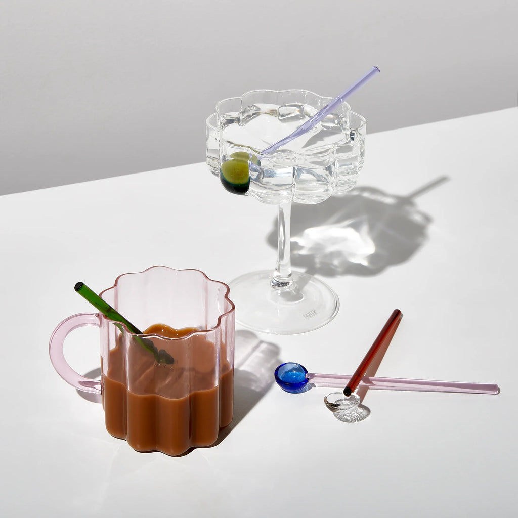 Colourful glass spoons styled with iced coffee and sparkling water in scalloped glassware – modern drinkware and accessories for everyday rituals.