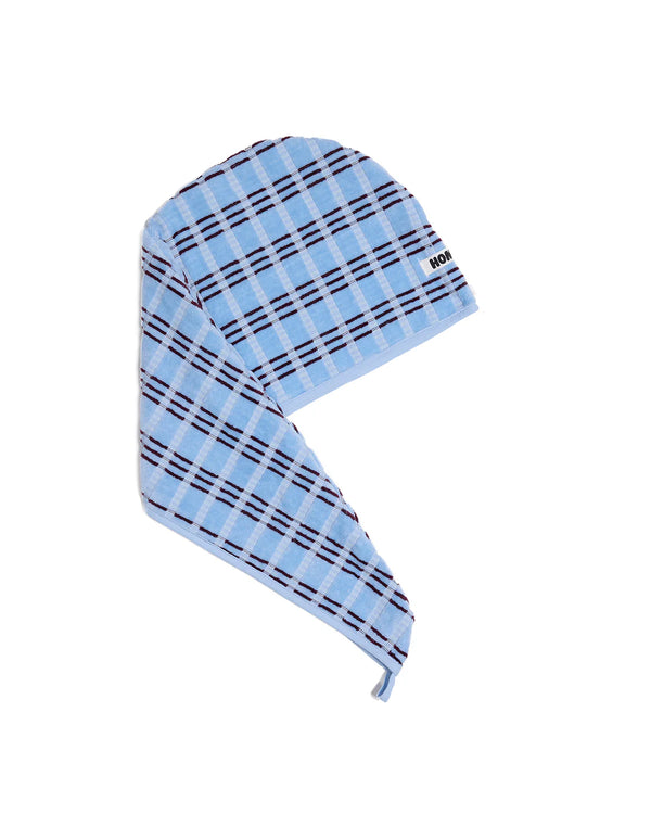 Blue plaid head towel with black stripes on a white background