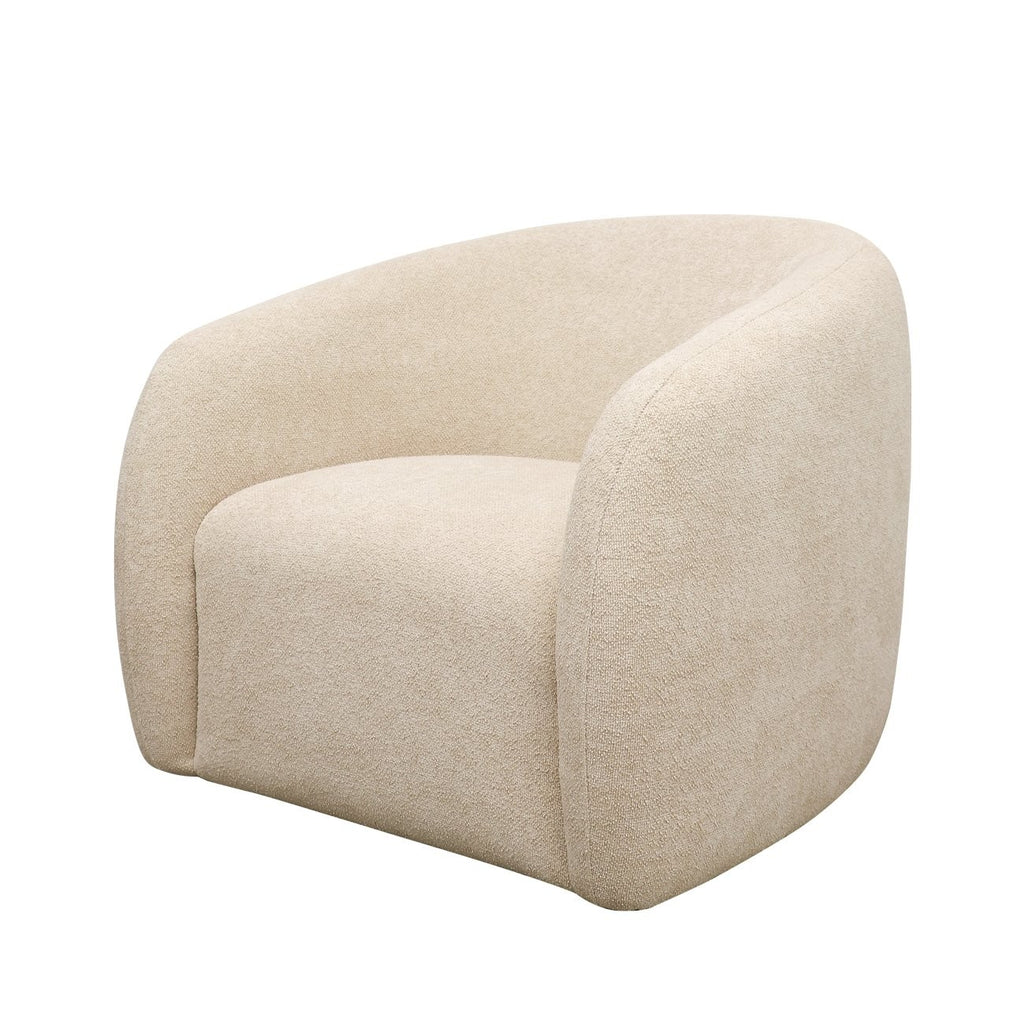 Curved armchair in soft cream boucle with a minimalist, low-profile silhouette and cocooning shape.