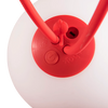 Close-up of a red plastic lamp base with two red curved arms extending upward, set against a white background.