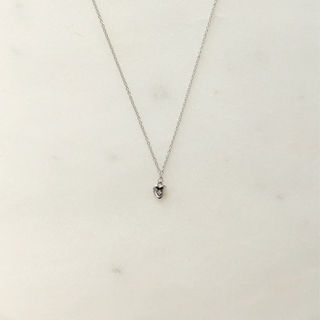 Silver necklace with a heart pendant and small diamond on delicate chain